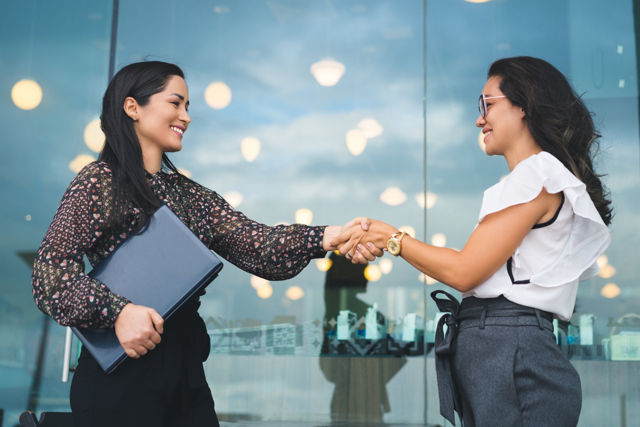 Business women shaking hands
